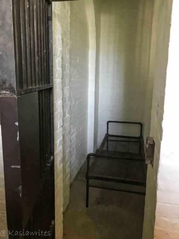 narrow prison cell with bed