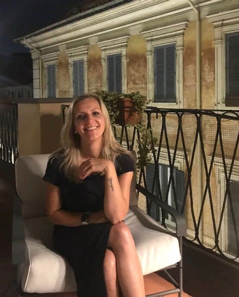 girl on a patio in Rome with an arm tattoo