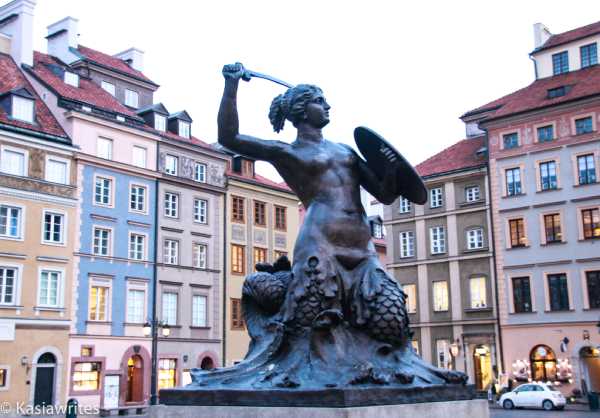 statue of a mermaid with a shield and a sword