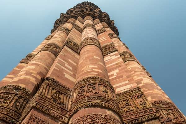 looking up Qutub Minar brick tower in Delhi 