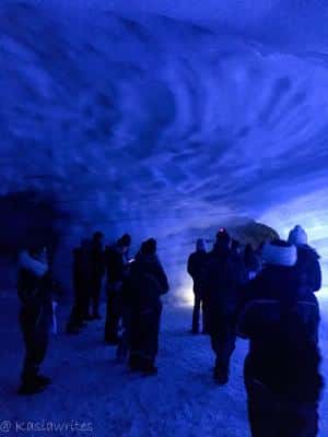 people gathered in blue ice cave Iceland