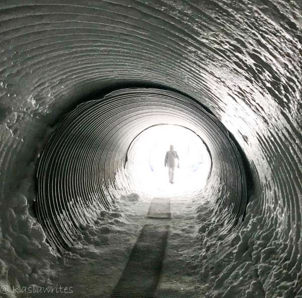 iced tunnel with a figure of a person outside