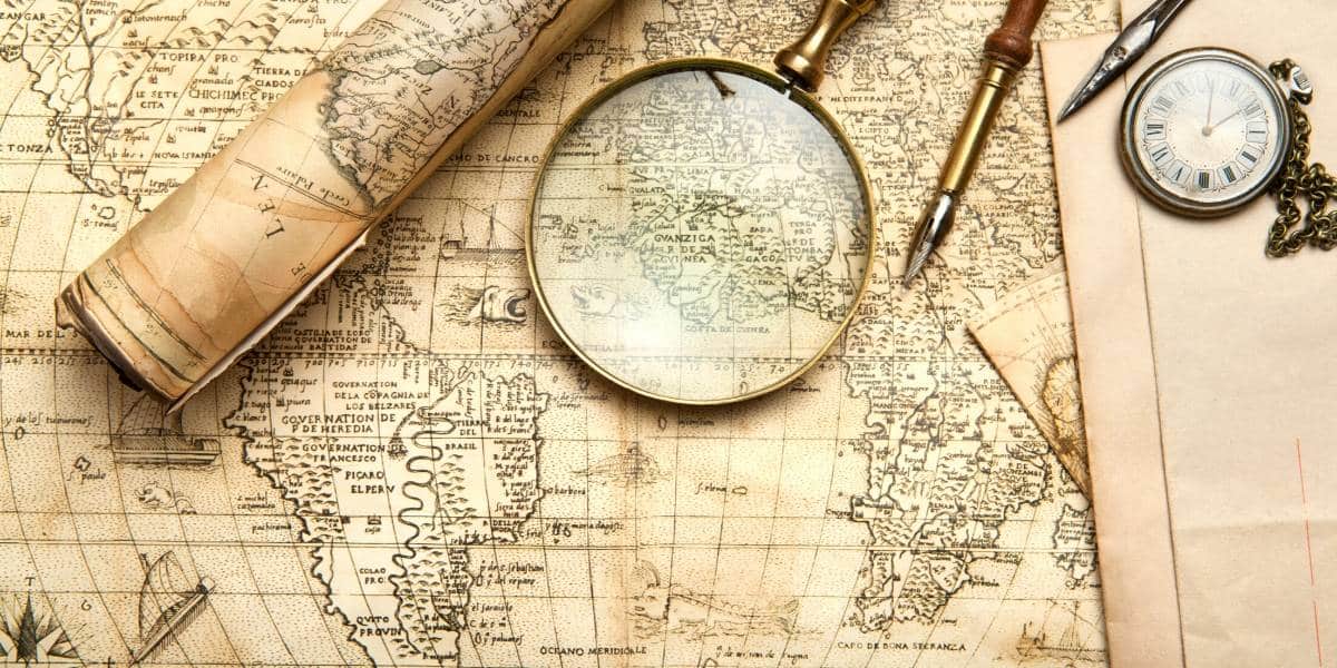 the world of travel with old map and magnifying glass