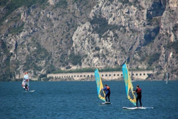 people sailing on Lake Garda with tunnel in the background that appeared in Quantum of Solace