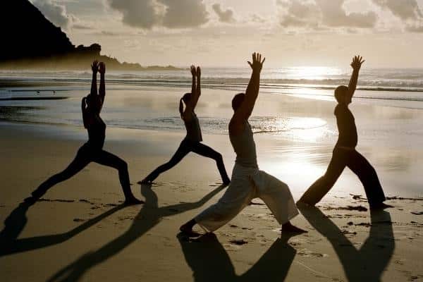 Yoga practice on the beach at sunset can do wonders for your well-being.