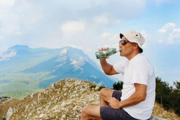 Man drinking water during a hike